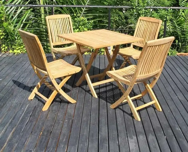 Teak Square Folding Table with natural finish set up on a patio